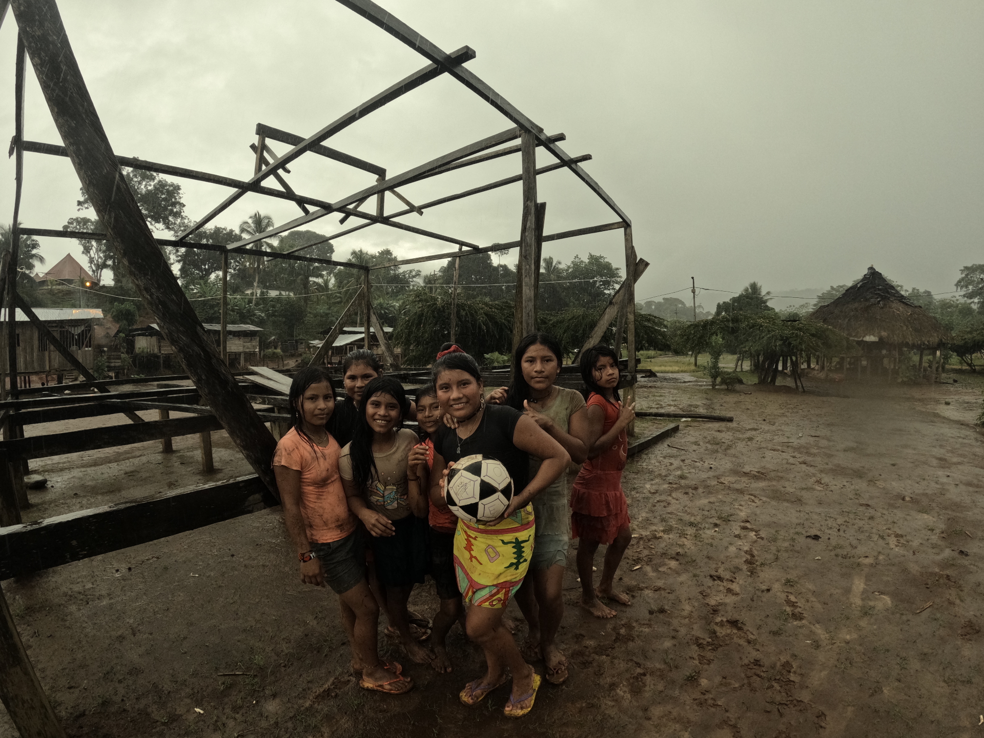 Local community children in a Darién village during rain